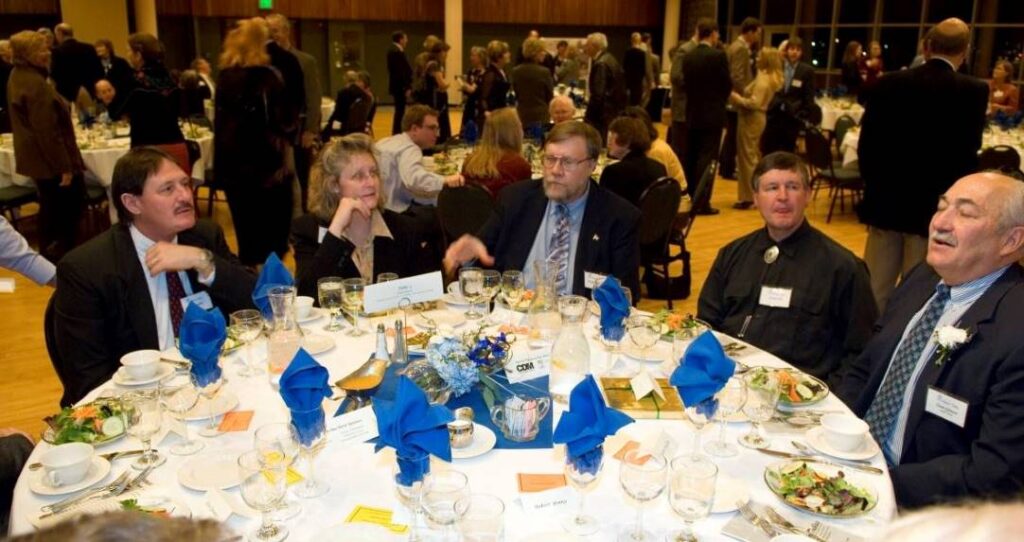people seated around a fancy dinner table