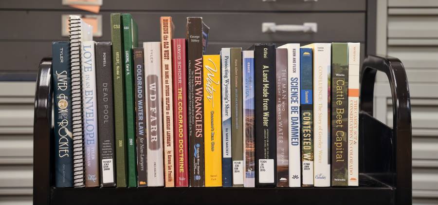 A library cart shelf of books related to water use and history
