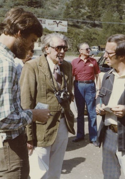 man being interviewed by two other men standing outside