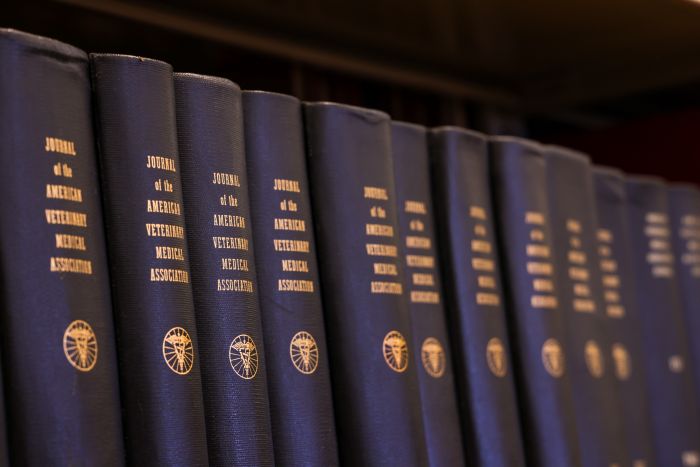 a shelf of bound copies of the Journal of the American Veterinary Medical Association